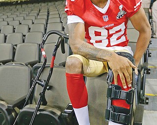 San Francisco 49ers wide receiver Mario Manningham answers reporters’ questions from the seats of the Mercedes Benz Superdome on Tuesday during media day for Super Bowl XLVII. Manningham, a Warren Harding graduate, will be sitting out Sunday’s big game after suffering a knee injury during a regular-season game against Seattle.