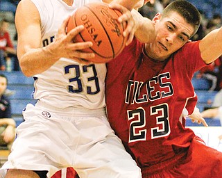 Poland’s George Chammas (33) fights off Niles defender James Tate (23) during the second half of Tuesday’s game in Poland. The Bulldogs bounced the Red Dragons, 69-51.