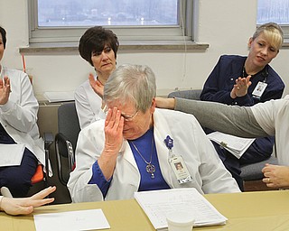 Pat “Pinky” Pinkerton of Salem is overcome with emotion at a surprise celebration at St. Elizabeth Health Center,
Youngstown, for her 50 years with the hospital. She gets an encouraging arm from registered nurse Donna Flauto.