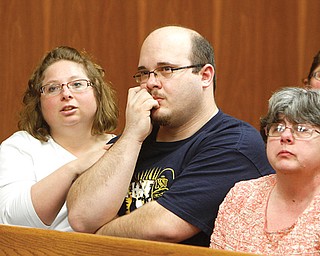 Shawn Tedesco, Teddy’s father, is comforted by an unidentified family friend, left, as the boy’s grandmother,
Sara Foltz, sits at right during Wednesday’s initial Struthers Municipal Court appearance of Zaryl G. Bush, 43,
who is charged with rape and murder in the boy’s death.