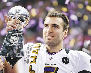 Baltimore quarterback Joe Flacco (5) holds the Vince Lombardi Trophy after the Ravens’ 34-31 Super Bowl win over the San Francisco 49ers on Sunday.