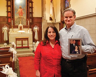 The Rev. Susan Brown and her husband, the Rev. Jerry Krueger, pastor of Trinity United Methodist Church, 30 W. Front St., Youngstown, are shown in the Chapel of Friendly Bells. He’s holding their wedding photo from Feb. 20, 2010. The clergy couple will perform walk-in weddings and vow renewals on Valentine’s Day, Feb. 14, in the downtown chapel. Couples must have marriage licenses and identification.