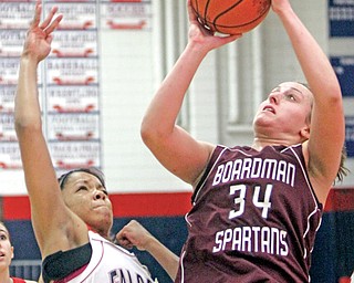 Boardman’s Emily Gibbs (34) shoots while Fitch’s Briana Edwards (34) defends during Monday’s game in Austintown. The Falcons won, 44-43.