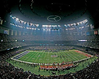 Fans and members of the Baltimore Ravens and San Francisco 49ers wait for power to return in the Superdome in New Orleans on Sunday during an outage in the second half of Super Bowl XLVII.