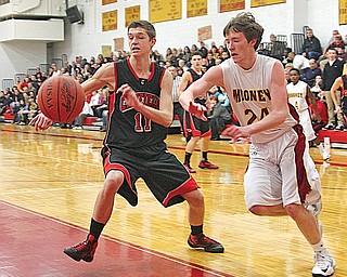 Canfield’s Andrew Midgley (11) and Cardinal Mooney’s George Brandenstein (24) chase the ball during their basketball game Tuesday at Mooney High School in Youngstown. Canfield edged Mooney, 60-59.