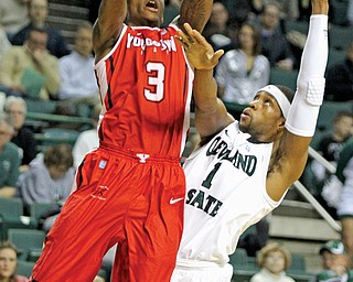 Youngstown State’s Kendrick Perry (3) attempts a jump shot against Cleveland State defender Sebastian Douglas (1) during the first half of Tuesday’s game at Wolstein Center in Cleveland. The Penguins came up short, losing 66-60.