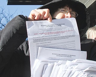 Anti-fracking activist Lynn Anderson holds a stack of petitions that she and others delivered to Youngstown City
Hall on Wednesday.