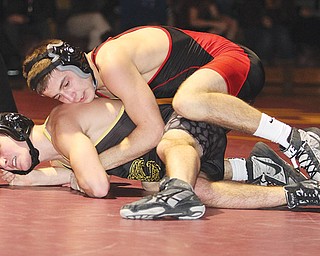 Girard’s Zane Chase (top) tries to get position against Liberty’s Robby Kurtz during their 120-pound match Wednesday night. Chase won a 13-3 major decision and the Indians beat the Leopards, 43-27.