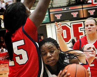 MADELYN P. HASTINGS | THE VINDICATOR
Youngstown's Brandi Brown (42) attempts to shoot the ball while Detroit's Yar Shayok (25) defends during the second half of the game at the Beeghly Center on February 7, 2012. The Penguins beat the Titans 58-53.