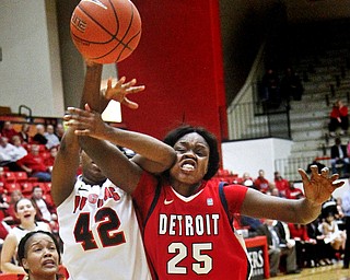 MADELYN P. HASTINGS | THE VINDICATOR
Youngstown's Brandi Brown (42) shoots the ball while Detroit's Demeisha Fambro (12) and Yar Shayok (25) try to block her during the first half of the game at the Beeghly Center on February 7, 2012. The Penguins beat the Titans 58-53.