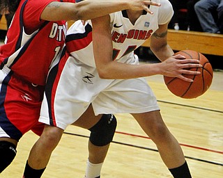 MADELYN P. HASTINGS | THE VINDICATOR
Youngstown's Karen Flagg (14) attempts to pass the ball while Detroit's Demeisha Fambro (12) defends during the first half of the game at the Beeghly Center on February 7, 2012. The Penguins beat the Titans 58-53.