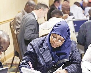 Karina Abdul-Haqq of Newark, N.J, center, completes a job application at a job fair sponsored by Swissport in Newark, N.J. The Labor Department reported Thursday that weekly applications for unemployment benefits fell 5,000 to a seasonally adjusted 366,000 last week.