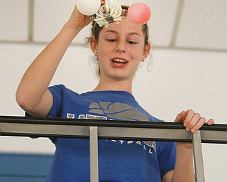 Melissa Thomas drops her egg capsule during an egg-drop contest at Hubbard community pool. Hubbard High School hosted its first science festival Thursday.