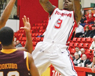 Youngstown State’s Kendrick Perry (3) leans back for a jump shot while being defended by Loyola’s London
Dokubo (13) during the second half of their Horizon League game Thursday at YSU’s Beeghly Center. A 3-pointer
by Blake Allen with 12 seconds remaining gave the Penguins the 60-59 win over the Ramblers. Perry finished with a team-high 18 points.