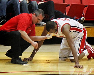 MADELYN P. HASTINGS | THE VINDICATOR
Youngstown State's Damian Eargle (21) takes a hit and suffers from a bloody nose on the court during triple overtime. He had to sit out the rest of the game. The Flames beat the Penguins 88-83 in triple overtime.