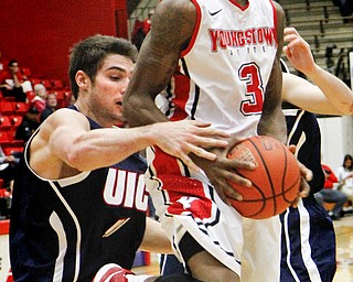 MADELYN P. HASTINGS | THE VINDICATOR
Youngstown State's Kendrick Perry (3) attempts to take a shot for the team while UIC's Gary Talton (4) defends during the second half of their game at the Beeghly Center on February 10, 2013. The Flames beat the Penguins 88-83 in triple overtime.