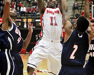 MADELYN P. HASTINGS | THE VINDICATOR
Youngstown State's DJ Cole (11) takes a shot for the team while UIC's Gary Talton (4) and Gabe Snider (2) defend during the first half of their game at the Beeghly Center on February 10, 2013. The Flames beat the Penguins 88-83 in triple overtime.