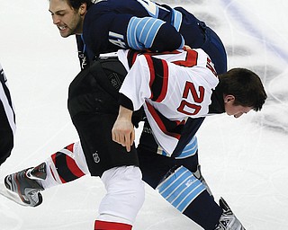 The Pittsburgh Penguins’ Robert Bortuzzo (41), top, and Ryan Carter (20) of the New Jersey Devils come to blows four seconds into the first period of Sunday’s NHL game in Pittsburgh. The Devils, who downed the Penguins in New Jersey on Saturday, handed Pittsburgh another loss. Final score: New Jersey 3, Pittsburgh 1.