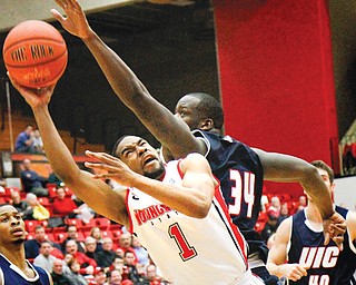 Youngstown State’s Blake Allen (1) is closely guarded by UIC defender Josh Crittle (34) during the second half of
Sunday’s game at YSU’s Beeghly Center. The Penguins went down to the Flames 88-83 in triple overtime.