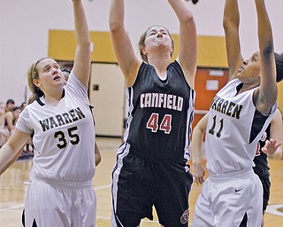 Canfield’s Sabrina Mangapora (44) goes up for a shot as Warren Harding’s Chelsea Dipaolo (35) and Patrai Murray (11) defend in the first half Monday night. Mangapora had 14 points and 10 rebounds in Canfield’s 50-33 victory.