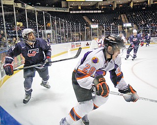 Phantoms defenseman Kale Bennett (28) and Team USA’s Sonny Milano (48) compete during a recent game at the Covelli Centre. Low attendance will be a factor in whether the team returns for a fifth season.