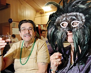 Mason Balestra and Flo Leonelli, both of Youngstown, enjoy the Mardi Gras party at Christ Our Savior Parish in Struthers. The parish hosted the event Monday for some 130 members.