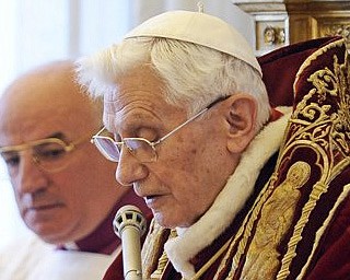 Pope Benedict XVI reads a document in Latin announcing his resignation during a meeting of Vatican cardinals at the Vatican on Monday.