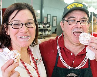 Aundrea Cika, Polish Youngstown director, and Jack Kravitz, owner of Kravitz Deli in Liberty, enjoy a paczki on Mardi Gras. The Fat Tuesday event was marked by with a Polish celebration at the traditional Jewish eatery.