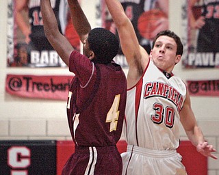 Canfield’s Marco DeLorenzo blocks a shot by Liberty’s Asim Pleas Jr. during the first quarter of Tuesday’s game at Canfield High School.