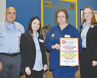 From left, Centers for Hearing Care’s Fortunato Figliano, Gina Capone, Deb Copeland and Dr. Susan Herr represent the seven office locations that are participating in the 2013 Harvest for Hunger funds and food campaign. Copeland holds a poster that says the business raised $3,613 and collected 1,445 pounds of
food in their 2012 effort for Harvest for Hunger.