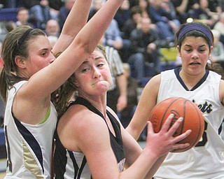 Lowellville’s Rachel Durbin (31) defends Canfield’s Sabrina Mangapora (44) during the first quarter of their basketball game Wednesday at Lowellville HIgh School. Mangapora scored 28 points for the Cardinals, who routed the Rockets, 67-25.