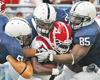 Youngstown State running back Adaris Bellamy is swarmed by Penn State defenders. Late Tuesday, Wisconsin athletic director Barry Alvarez said on the radio that the Big Ten will stop scheduling games against FCS teams, a move that could cost YSU hundreds of thousands of dollars a year.