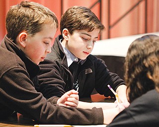 Willowcreek Learning Center students, from left, Ethan Ball, Jacob Snyder and Grace Haddad participate in the Mathbowl, one of the events Thursday at MATHCOUNTS in the Chestnut Room of Youngstown State University’s Kilcawley Center.