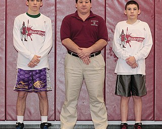 Nick Mancini, left, a 113-pound grappler, is a two-time state qualifier and the winningest wrestler in Boardman High School history — thanks to the efforts of his coach, Dom Mancini, center, who is also his dad. His younger brother Vince Mancini, right, a sophomore, competes in the 106-pound weight class.