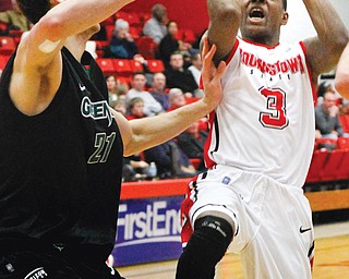YSU’s Kendrick Perry (3) attempts to shoot the ball while Green Bay’s Alec Brown (21) tries to block his shot during the second half of Sunday’s game at the Beeghly Center. Green Bay beat the Penguins 71-54.