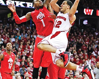Wisconsin’s Traevon Jackson (12) shoots against Ohio State’s Deshaun Thomas during the second half of a game Sunday in Madison, Wis.