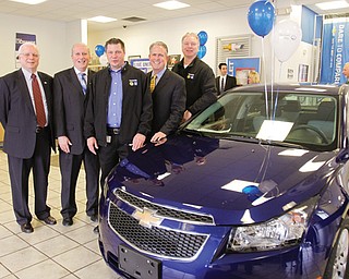 United Way officials and other leaders of the 2012 United Way of Youngstown and the Mahoning Valley campaign stand with the Chevrolet Cruze donated as a campaign incentive. From left, Thomas J. Krysiek, Trumbull County United Way president and chief professional officer; Robert Hannon, Youngstown/Mahoning Valley United Way
president; David Green, president of United Auto Workers Local 1714 at General Motors Lordstown; Greg Greenwood, owner of Greenwood Chevrolet; and Glenn Johnson, president of UAW Local 1112 at GM Lordstown.