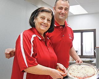 Tina Cocca, left, and her son, Steve, who oversees the Cocca’s Pizza chain, recently moved their flagship
location to the former New York Music building in Boardman. The new quarters are bigger, with eight ovens that can cook 48 pizzas every 15 minutes. There also are menu additions, such as panini and authentic Italian
sandwiches. The company hired 10 new employees.