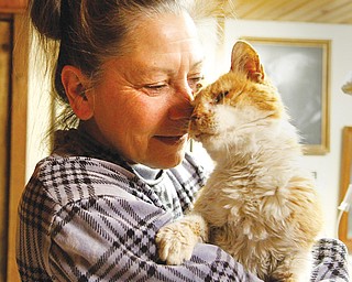 Diane Less, co-founder of Angels for Animals, cradles Valentine, the cat abandoned from a car Feb. 14 and rescued by a police lieutenant. Less hopes that Valentine, who is being nursed back to health, will be ready to be adopted into a new home in about a week.