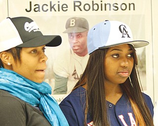 Choffin Career and Technical Center seniors, above from left, Delana Robinson and Charisse Brown, listen to the Black History program Wednesday at the school. W. James Cobbin, right, was the featured speaker. Cobbin, a city resident, played baseball in the American Negro League in the 1950s.