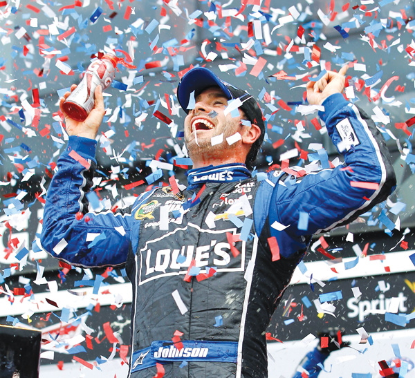 Jimmie Johnson celebrates winning Sunday’s Daytona 500 at Daytona International Speedway in Daytona Beach,
Fla. Johnson won the race for the second time, but it was Danica Patrick who earned a first by becoming the first
woman to lead a lap in a race in Nascar’s top series.