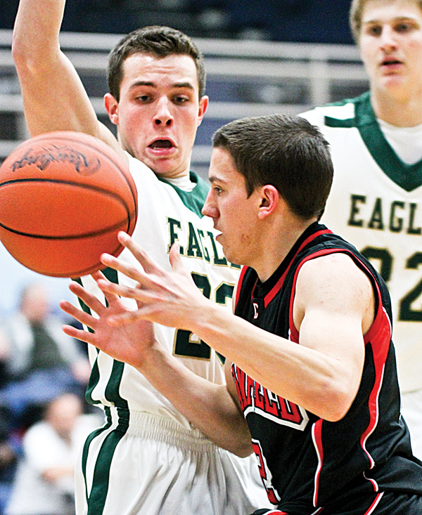 Canfield’s Cole Pryjma (2) moves around GlenOak’s Mike Hronek (23) during Monday’s Division I tournament game in Alliance.