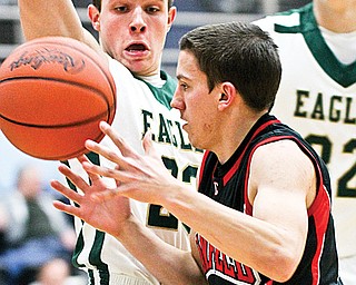Canfield’s Cole Pryjma (2) moves around GlenOak’s Mike Hronek (23) during Monday’s Division I tournament game in Alliance.