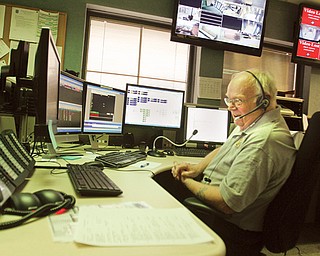 Dispatcher Bill Davis checks a multitude of screens and readouts in the new Boardman-Austintown joint dispatch center. The departments joined to get a digital radio system to comply with federal mandates, and the Mill Creek Metroparks have joined with the system.