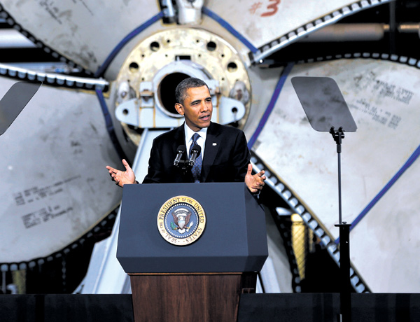 Standing in front of a ship propeller, President Barack Obama speaks about automatic defense-budget cuts on Tuesday at Newport News Shipbuilding in Newport News, Va.