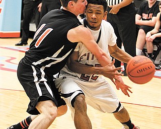 Fitch’s Quincy Higgins (22) and John-Mark Weisman of Howland butt heads literally during the Division I sectional basketball game Tuesday at Alliance High School. The Falcons stunned the Tigers, 70-67, in overtime.