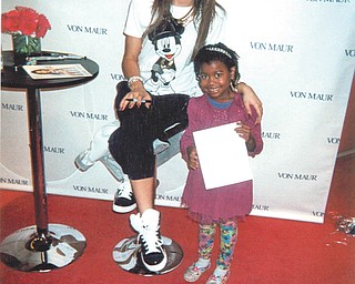 Marcilee Kinerman, 6, of Alpharetta, Ga., beams while meeting her favorite star from the Disney Channel: Zendaya, who plays Rocky Blue on "Shake It Up." Marcilee is the granddaughter of Randolph Jones of Youngstown.