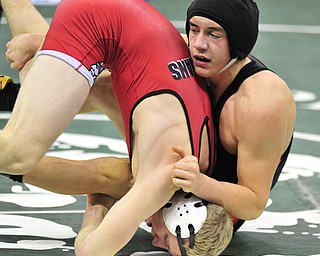 Howland's Jordan Radich hangs on to Wauseon's Aaron Schuette while avoiding being turned onto his back.