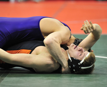 Howland's Josh Grodesky tries to get out from under Lexington's Jacob Kasper.