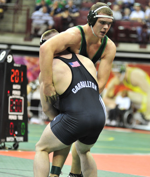 West Branch's Logan Sharp tries to avoid being slamed down by Carrollton's Austin Bentley.